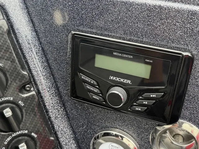 Slide: The Image of Close-up of a boat control panel featuring a Kicker media center and various switches. - 28
