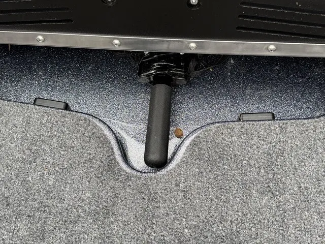 Slide: The Image of Close-up of a boat deck with gray carpet and a black handle. - 27
