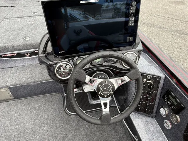 Slide: The Image of The image shows the cockpit of a 2027 Phoenix 921 Elite X II boat with a large screen. - 15