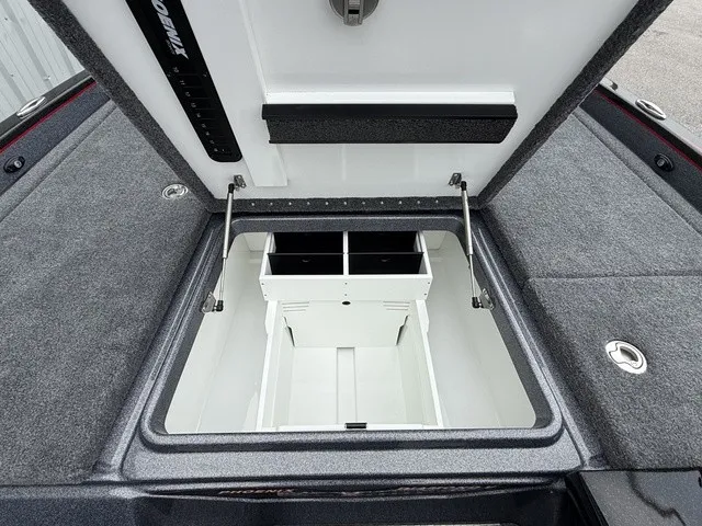 Slide: The Image of The image shows an open storage compartment on a boat, surrounded by gray carpeting. - 19