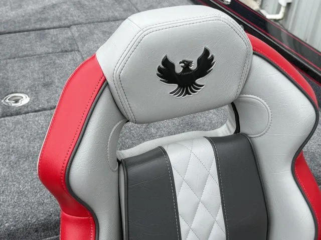 Slide: The Image of A gray and red boat seat with an embroidered phoenix logo on the backrest. - 10