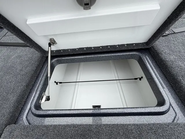 Slide: The Image of Open storage hatch on a boat with gray carpeted flooring. - 20