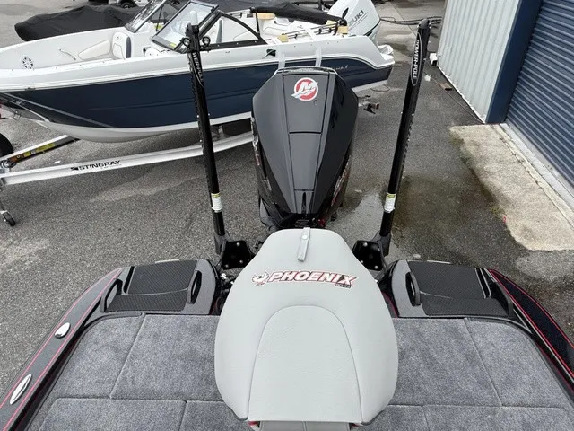 Slide: The Image of The image shows the rear of a 2027 Phoenix 921 Elite X II boat with an outboard motor. - 11
