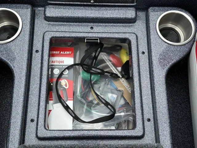Slide: The Image of A storage compartment with safety gear and cup holders on a boat. - 26