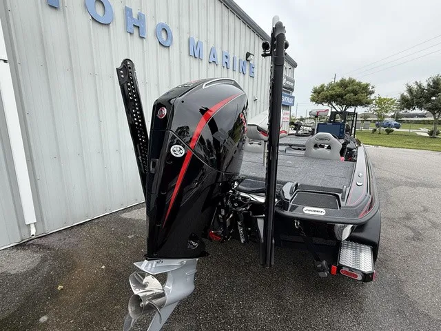 Slide: The Image of A 2027 Phoenix 921 Elite X II is parked. The outboard motor is prominently visible. - 6
