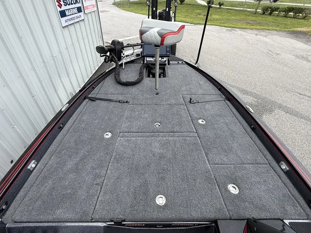 Slide: The Image of The image shows the deck of a 2027 Phoenix 921 Elite X II boat with gray carpeting. - 18