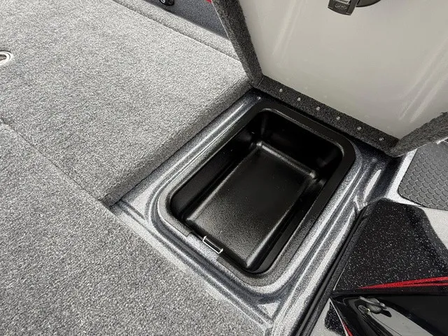 Slide: The Image of An open storage compartment on a boat with gray carpeting. - 22