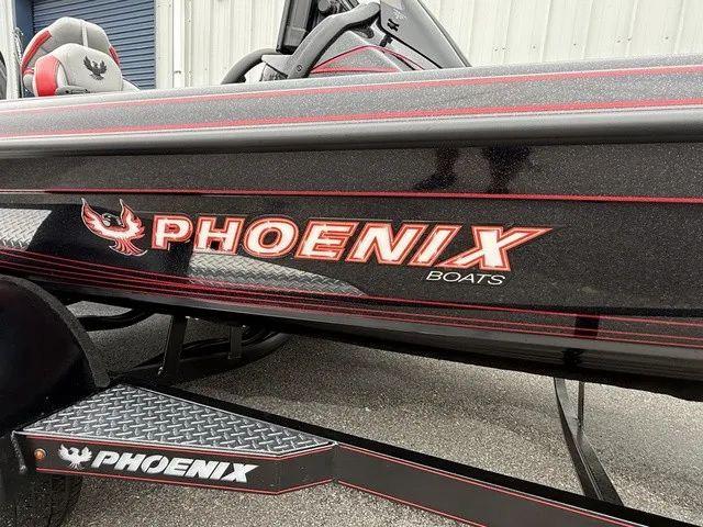 Slide: The Image of The image shows a 2027 Phoenix 921 Elite X II boat with a prominent logo on the side. - 3