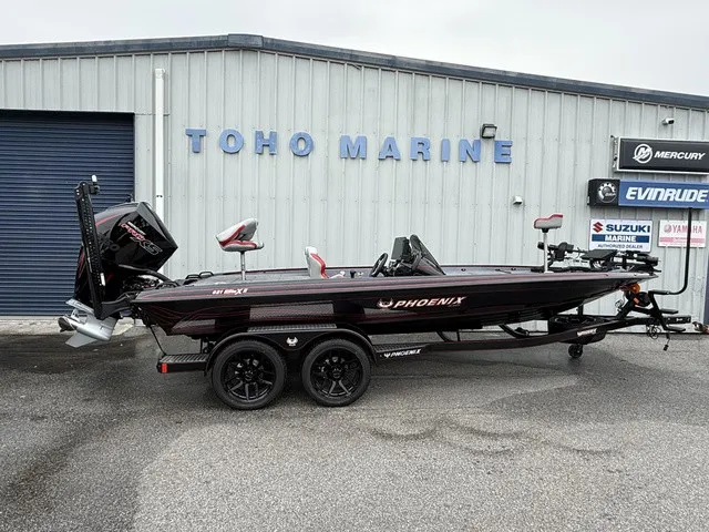 The Image of A 2027 Phoenix 921 Elite X II boat on a trailer in front of a building labeled "TOHO MARINE." - 1