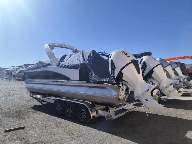 Slide: The Image of A 2027 Avalon Excalibur LTD Twin SS 25 FT on a trailer. Two engines are visible. - 4