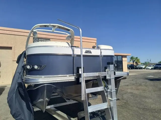 Slide: The Image of An Avalon Excalibur LTD Twin SS 25 FT boat on a trailer in front of a building. - 6