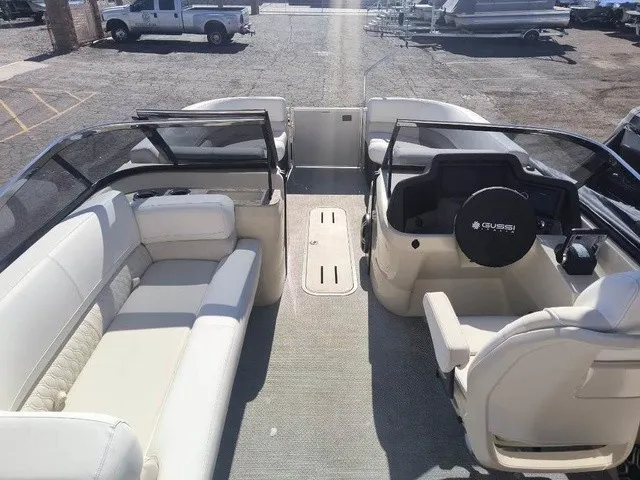 Slide: The Image of The image shows the interior of a 2027 Avalon Excalibur LTD Twin SS 25 FT. It features white upholstered seating and a modern dashboard. - 8