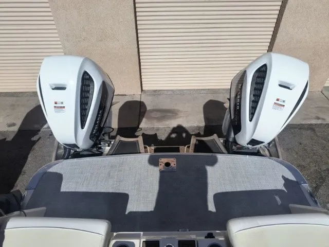 Slide: The Image of Two powerful outboard engines are mounted on the stern of a boat, resting on a concrete floor. - 18