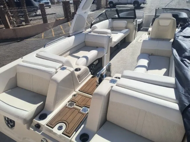 Slide: The Image of Luxurious pontoon boat with cream upholstery, wood flooring, and multiple outdoor seating areas. - 13