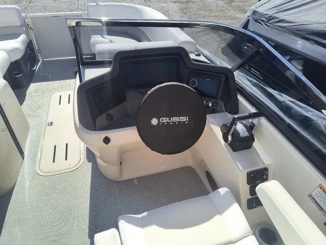 Slide: The Image of The image shows the cockpit of a 2027 Avalon Excalibur LTD Twin SS 25 FT with a modern helm. - 9