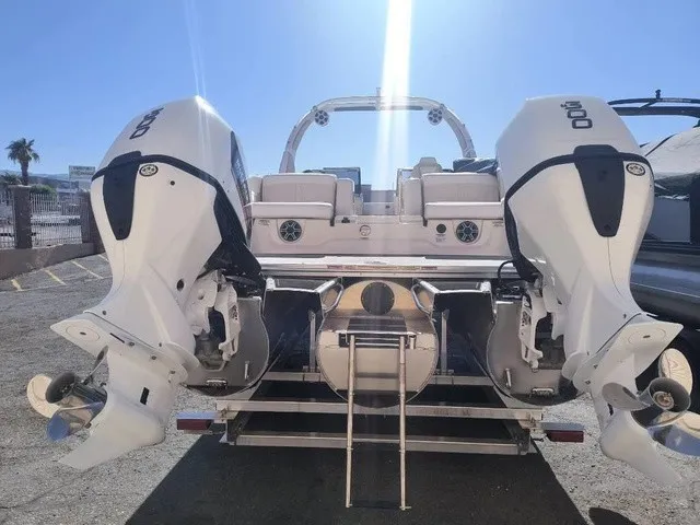 Slide: The Image of The image shows the rear of an Avalon Excalibur LTD Twin SS 25 FT with two powerful outboard engines. - 10