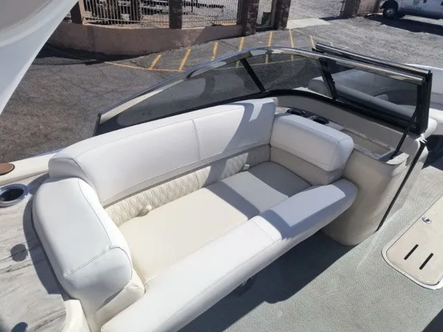 Slide: The Image of The image shows the luxurious white seating area of an Avalon Excalibur LTD Twin SS 25 FT boat. - 12