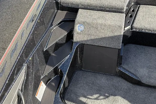 Slide: The Image of The image shows the interior of a 2026 Skeeter ZXE20 boat with gray carpeting. - 25