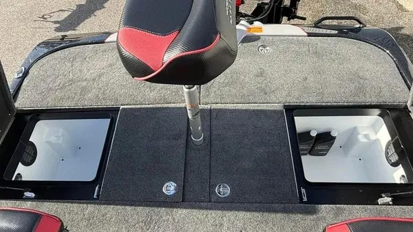 Slide: The Image of The image shows the deck of a Skeeter ZXE20 boat with two storage compartments and a seat. - 23