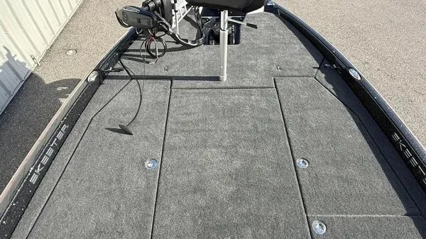 Slide: The Image of The image shows the deck of a 2026 Skeeter ZXE20 boat with gray carpeting. - 14
