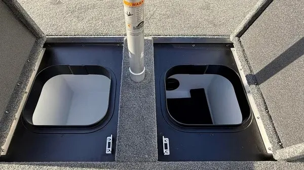 Slide: The Image of Two open storage compartments on a boat with gray carpeted flooring. - 22