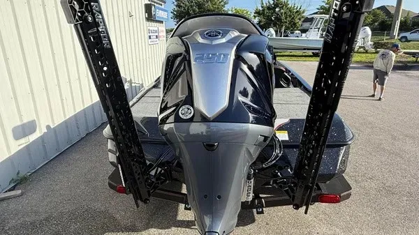 Slide: The Image of A 2026 Skeeter ZXE20 boat with a powerful outboard motor, parked on a trailer. - 6