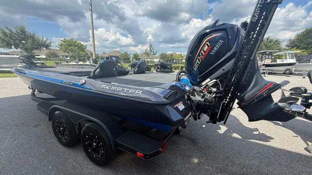 Slide: The Image of A modern 2027 Skeeter ZXE21 with a powerful outboard motor, parked on a trailer. - 5