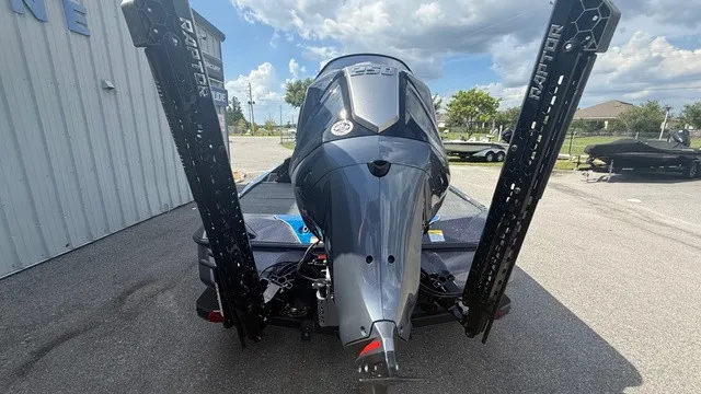 Slide: The Image of Rear view of a Skeeter ZXE21 boat with a powerful outboard motor and Power-Pole anchors. - 3