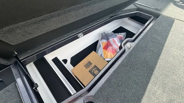 Slide: The Image of An open storage compartment on a boat with boxes and accessories. - 15
