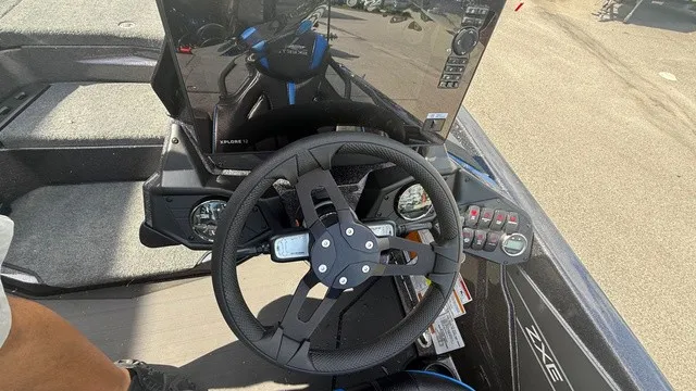 Slide: The Image of The image shows the cockpit of a 2027 Skeeter ZXE21 boat with a modern steering wheel and instruments. - 10