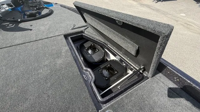 Slide: The Image of The image shows the storage compartment of a 2027 Skeeter ZXE21 boat with two black boxes. - 14