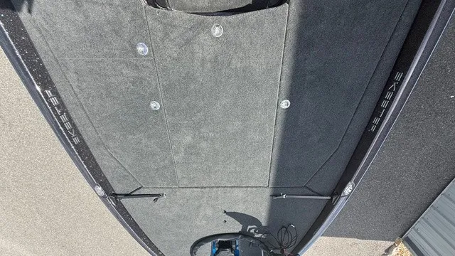Slide: The Image of The image shows the deck of a 2027 Skeeter ZXE21 boat with gray carpeting. - 7