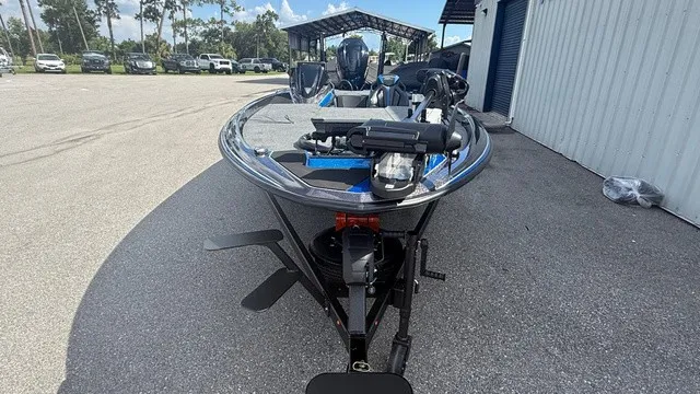 Slide: The Image of A modern 2027 Skeeter ZXE21 sits on a trailer in an outdoor area. - 8
