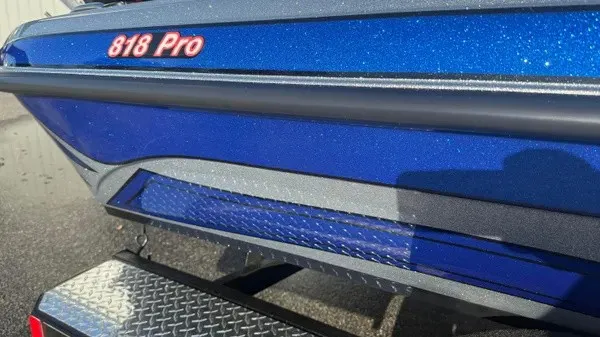 Slide: The Image of Close-up of a blue Phoenix 818 Pro boat from 2027 with a shiny finish. - 3