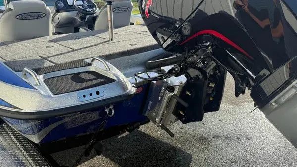 Slide: The Image of The image shows the rear of a Phoenix 818 Pro boat with an outboard motor. - 6