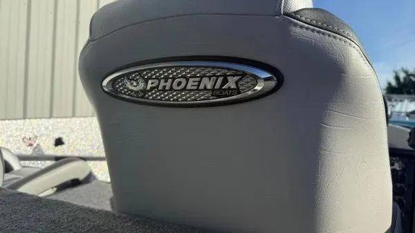 Slide: The Image of Close-up of a Phoenix 818 Pro boat seat with the Phoenix logo on the backrest. - 22