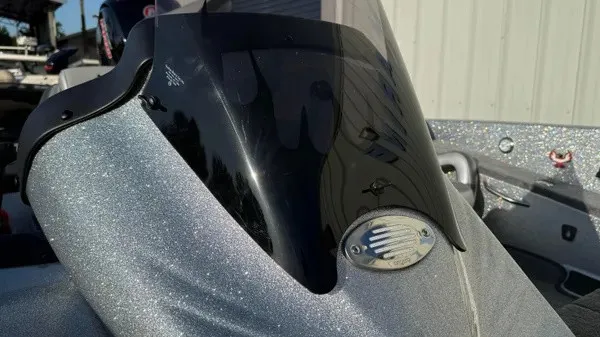 Slide: The Image of Close-up of a shiny boat deck with tinted windshield and silver emblem. - 10