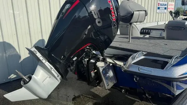 Slide: The Image of A Phoenix 818 Pro boat with a powerful outboard motor, docked at a marina. - 5