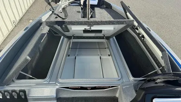 Slide: The Image of The image shows the open storage compartment of a 2027 Phoenix 818 Pro boat. - 13