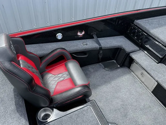 Slide: The Image of The image shows the interior of a 2027 Phoenix 920 Elite X II boat with a red and black seat. - 16