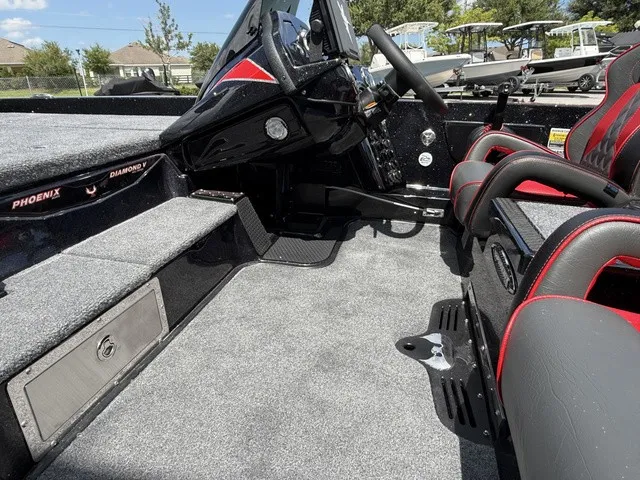 Slide: The Image of The image shows the cockpit of a 2027 Phoenix 920 Elite X II boat with gray carpeting. - 10