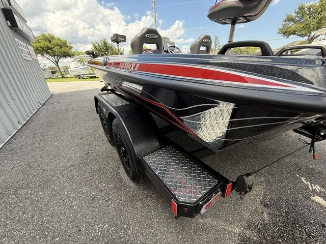 Slide: The Image of A 2027 Phoenix 920 Elite X II boat on a trailer, featuring red accents. - 6