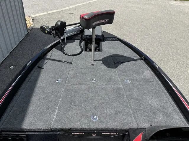 Slide: The Image of The image shows the deck of a 2027 Phoenix 920 Elite X II boat with a seat and fishing gear. - 12