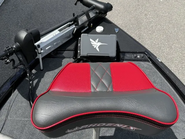 Slide: The Image of A red and black seat on a Phoenix 920 Elite X II boat, with controls and electronics. - 13