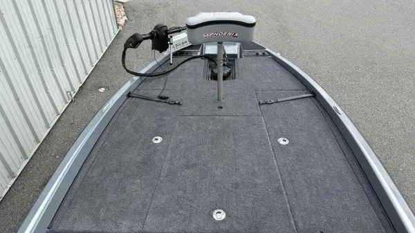 Slide: The Image of The image shows the deck of a 2027 Phoenix 920 Elite X boat with gray carpeting. - 10