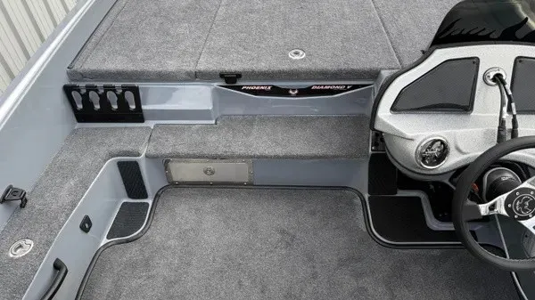 Slide: The Image of Interior view of a 2027 Phoenix 920 Elite X boat with gray carpeting and a steering console. - 21
