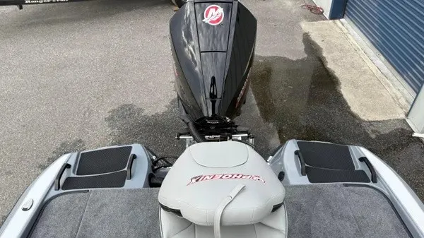 Slide: The Image of The image shows the rear of a 2027 Phoenix 920 Elite X boat with an engine. - 18