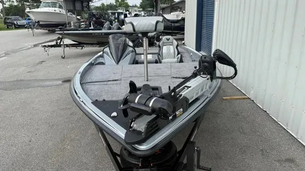 Slide: The Image of A 2027 Phoenix 920 Elite X on a trailer in a marina area. - 9