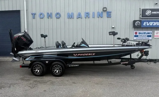 The Image of A 2026 Phoenix 20 XE boat on a trailer in front of a building labeled "TOHO MARINE." - 1