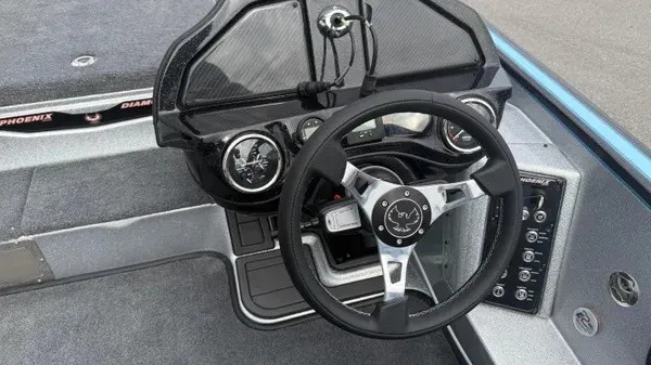 Slide: The Image of The image shows the cockpit of a 2026 Phoenix 20 XE boat with a modern steering wheel and instruments. - 12